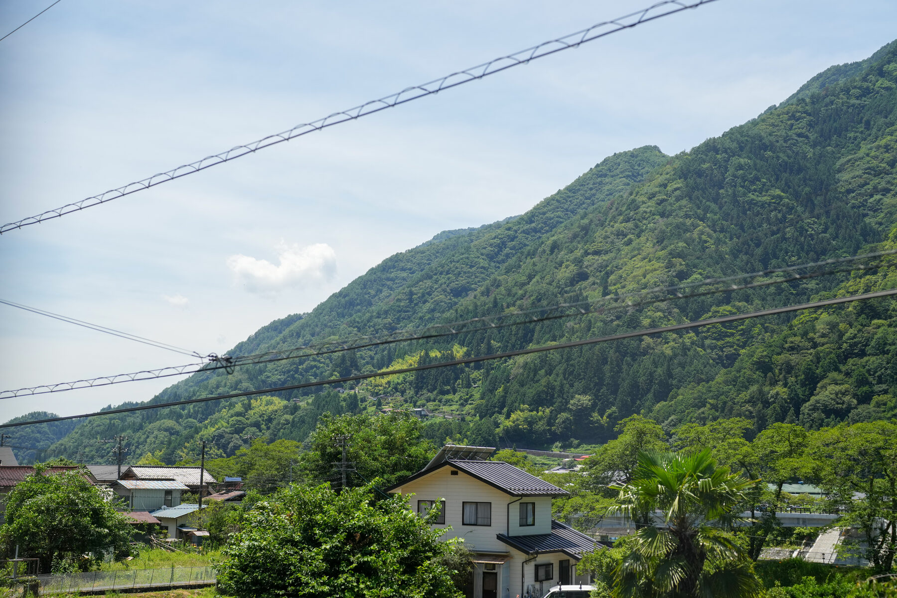 医院周辺に広がる飯田市の山の景色